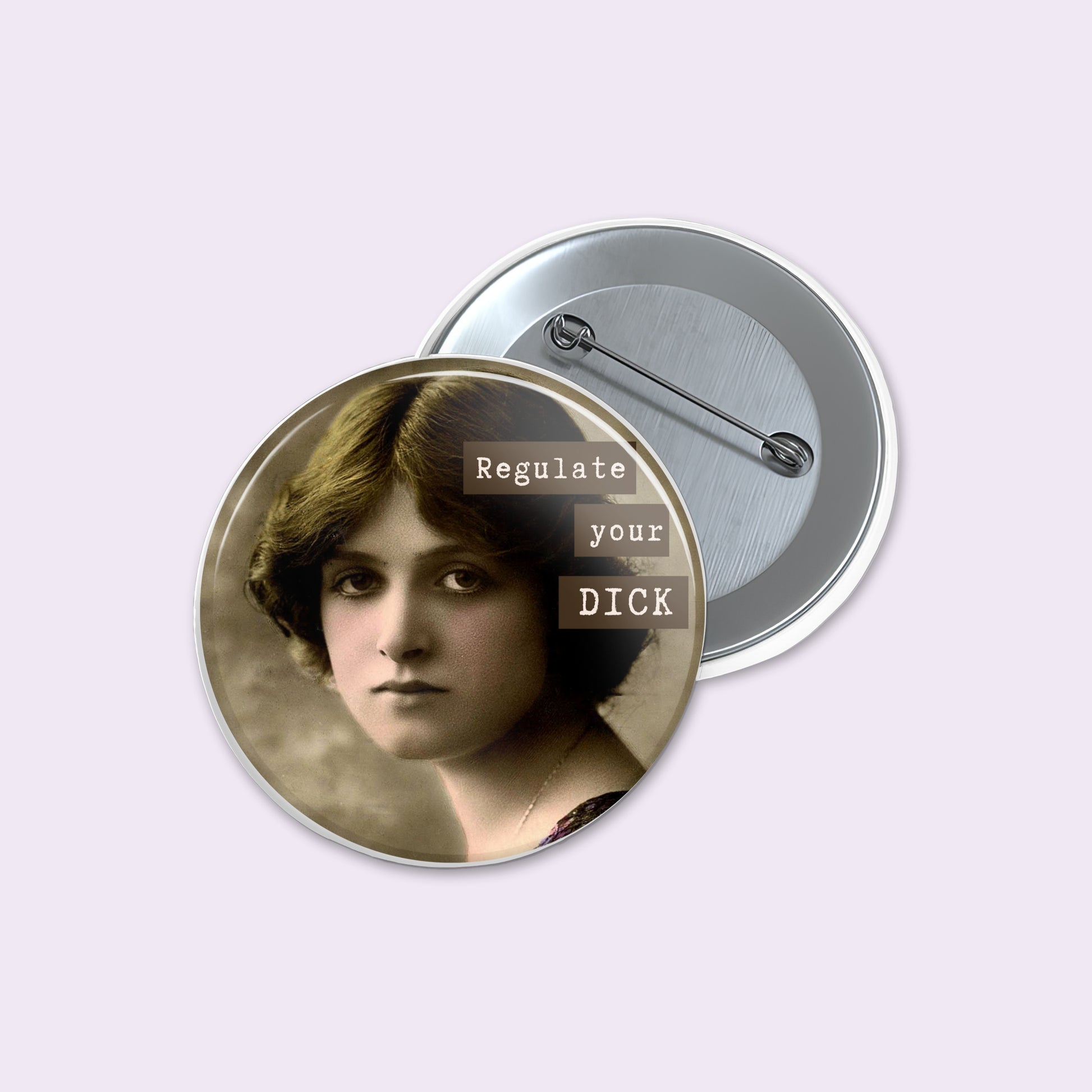 Round pinback button on a pale lavender background showing a vintage-style portrait of a woman with the text 'Regulate your DICK' overlaid in white and brown blocks.