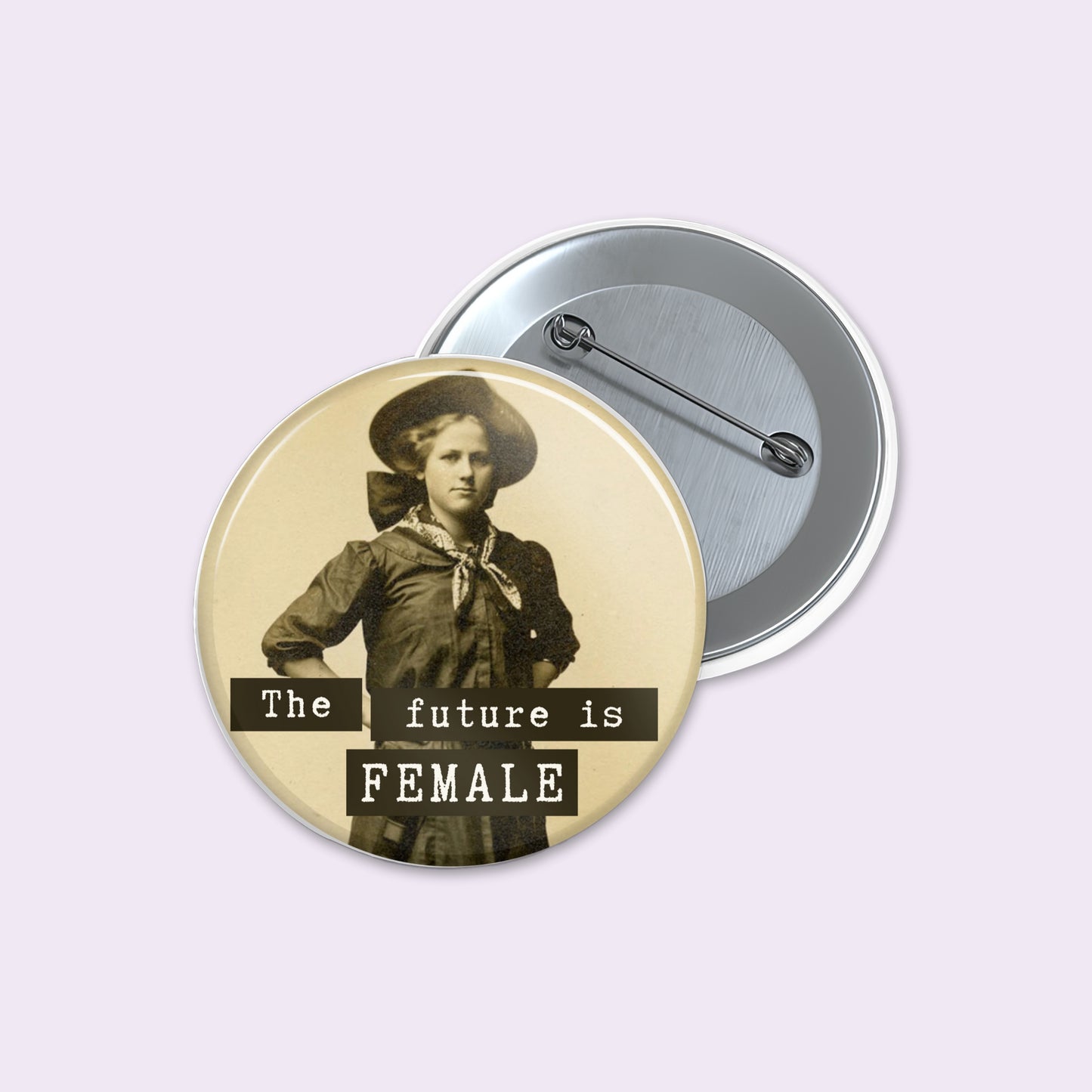 Round pinback button shows a vintage-style sepia portrait of a woman with the text 'The future is FEMALE' in black banners.