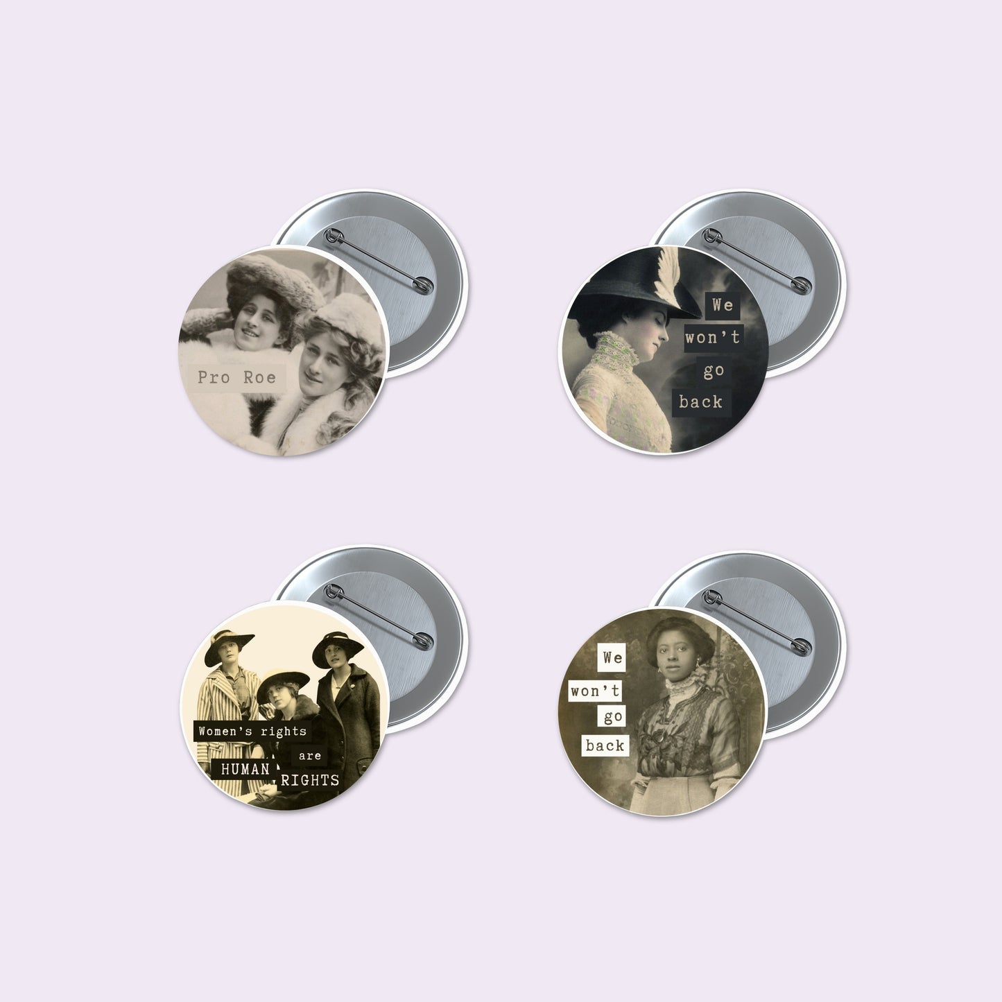 Four round pinback buttons with vintage-style black and white historical photographs and text slogans, shown with their silver metal backs on a pale lavender background.