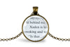 Necklace with pendant featuring text from an upcycled book page, set under glass and into a bronze-plated bezel on a white background - Whimsy Spirit Shop