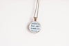Necklace with upcycled book page pendant displaying text  on a white background