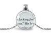 Upcycled book page pendant necklace with pendant featuring book page text, on a white background