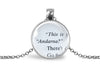 Silver-toned necklace with an upcycled book page pendant displaying text on a white background
