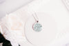 Historical romance necklace made from upcycled book page text under glass cabochon, shown against a white background
