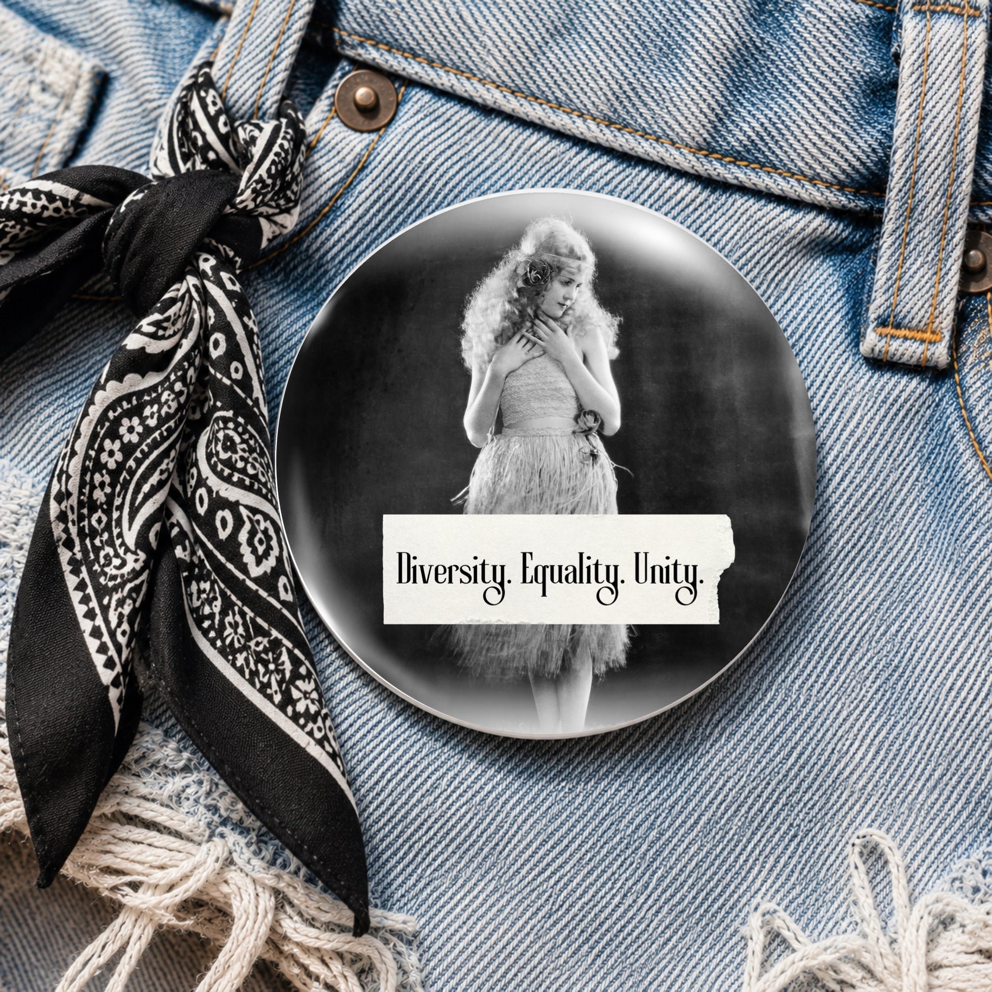 Retro woman on a pin back button with writing "Diversity. Equality. Unity." on denim