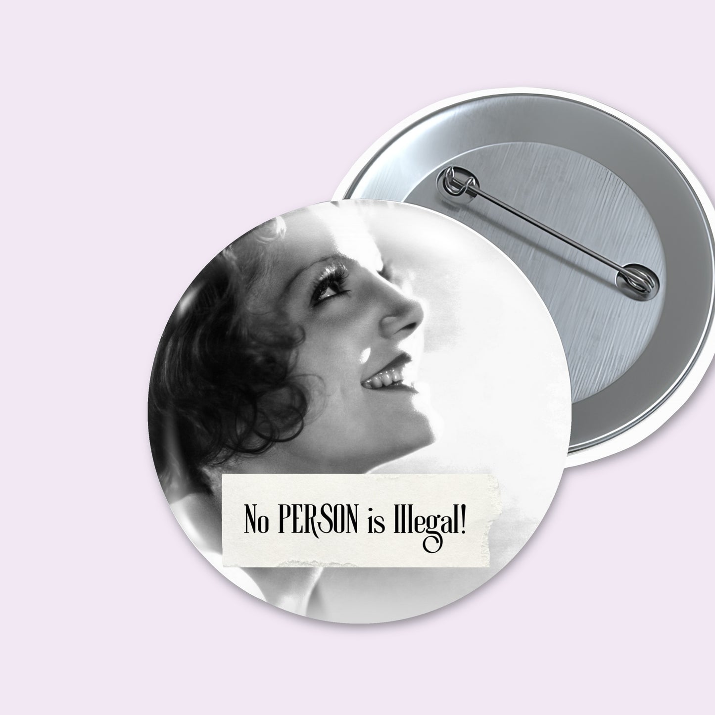 Two round pinback buttons on a pale lavender background. The front button shows a black-and-white vintage-style portrait of a smiling woman with the text 'No PERSON is Illegal!' on a white banner.