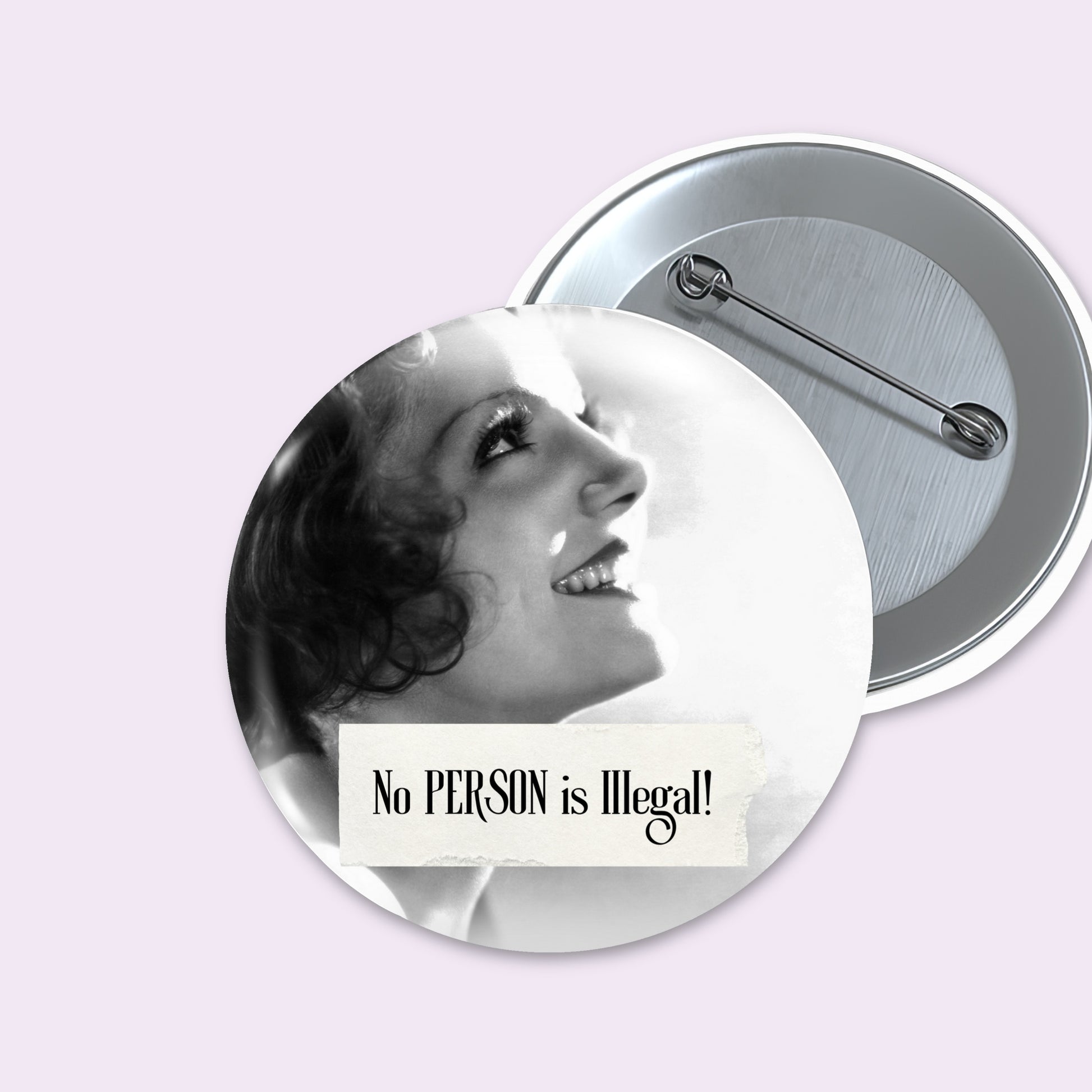 Two round pinback buttons on a pale lavender background. The front button shows a black-and-white vintage-style portrait of a smiling woman with the text 'No PERSON is Illegal!' on a white banner.