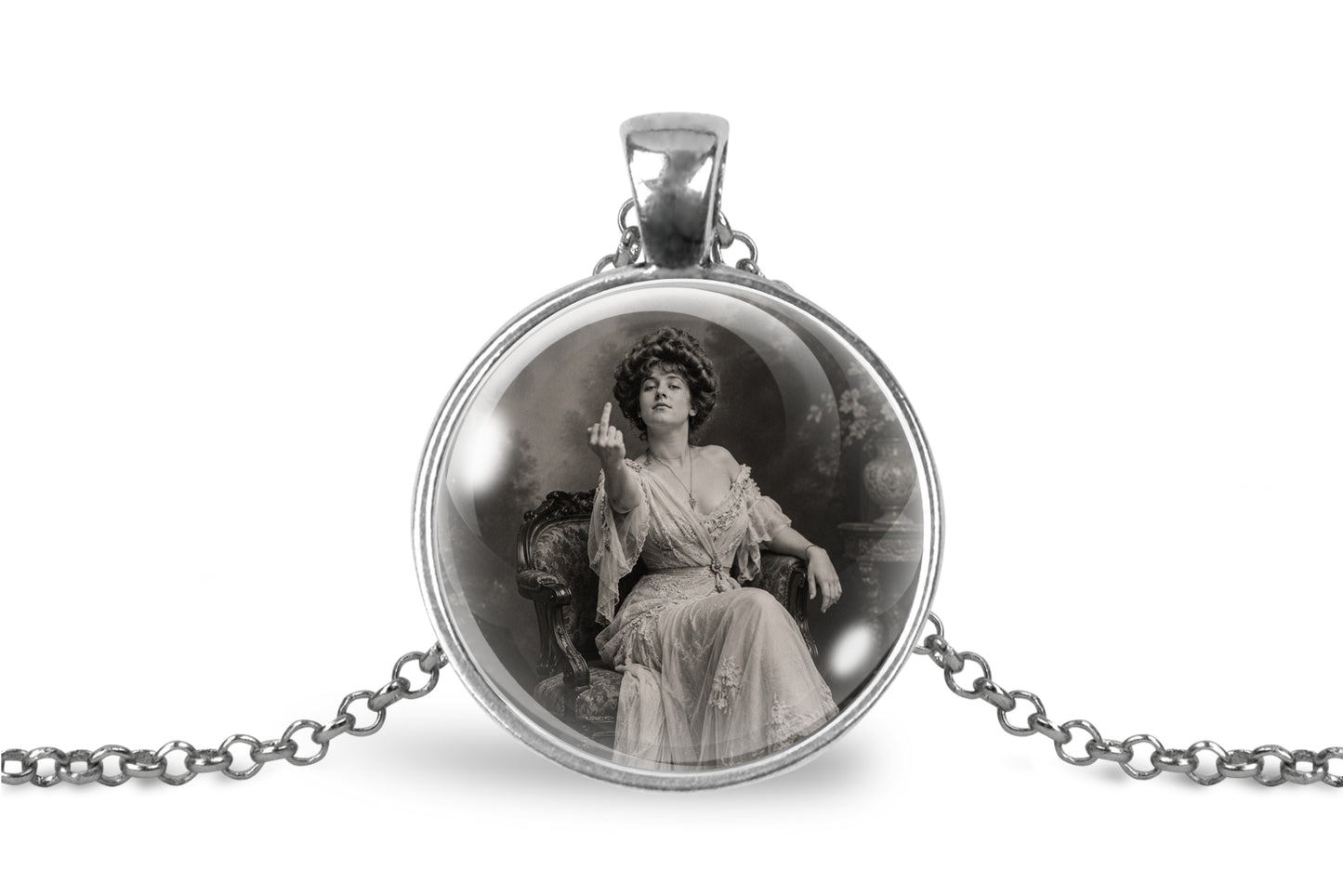 A silver-toned pendant necklace featuring a circular cabochon with a black-and-white vintage portrait of a seated woman, shown on a white background with part of the chain visible.