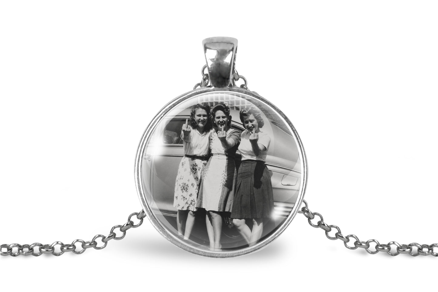 A silver round pendant necklace featuring a black-and-white photo of three women flipping the bird, displayed on a clean white background with a silver chain.