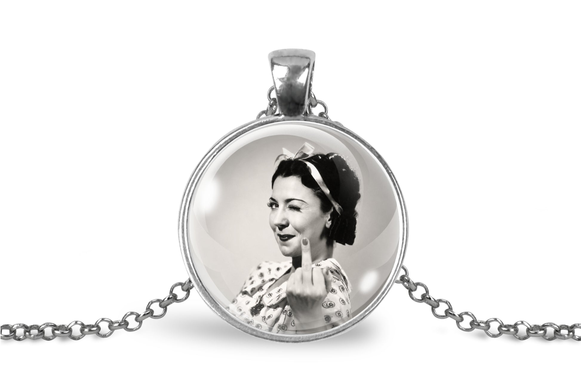 A silver-toned round pendant necklace on a white background, featuring a black-and-white vintage portrait of a woman making a middle finger gesture.
