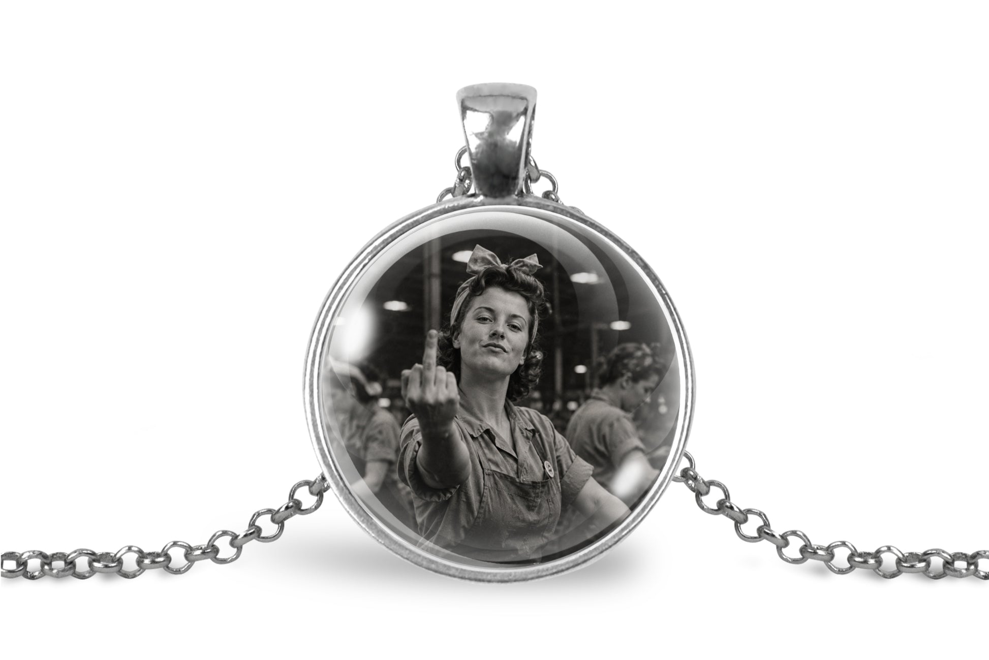 A silver-toned round pendant necklace on a white background, featuring a black-and-white photo of a woman holding up her middle finger inside a dome glass cover.