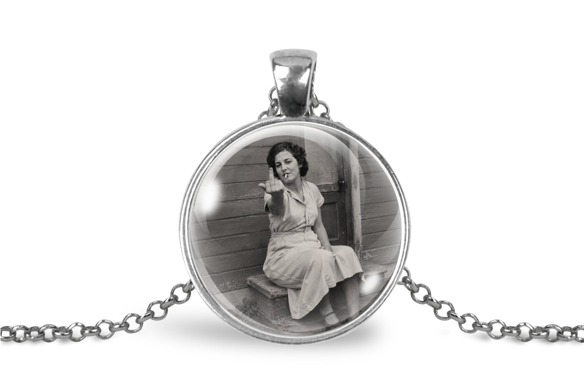 A silver round pendant necklace featuring a black and white vintage photograph of a woman sitting on a porch, suspended on a silver chain against a white background.