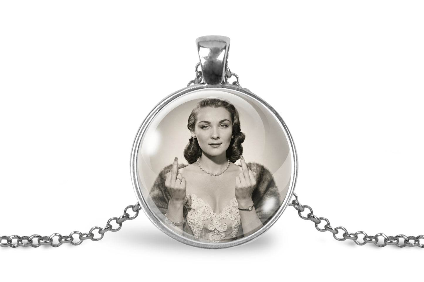 A silver-toned round pendant necklace on a white background, featuring a black-and-white vintage-style portrait of a woman making the middle finger gesture.
