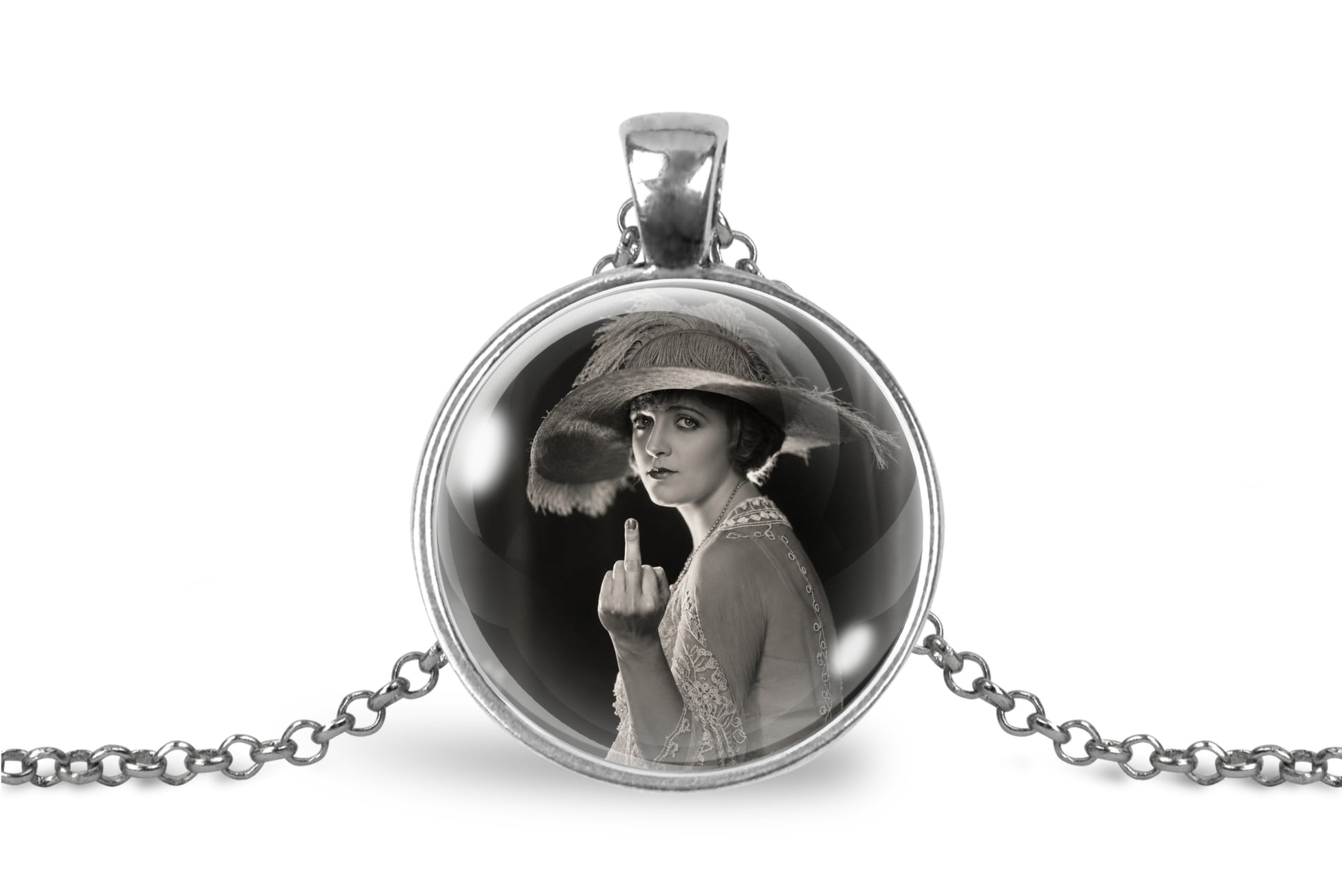 A silver pendant necklace featuring a circular glass dome with a black-and-white vintage portrait of a woman in a hat gesturing with her middle finger, shown on a white background with the chain extending to both sides.