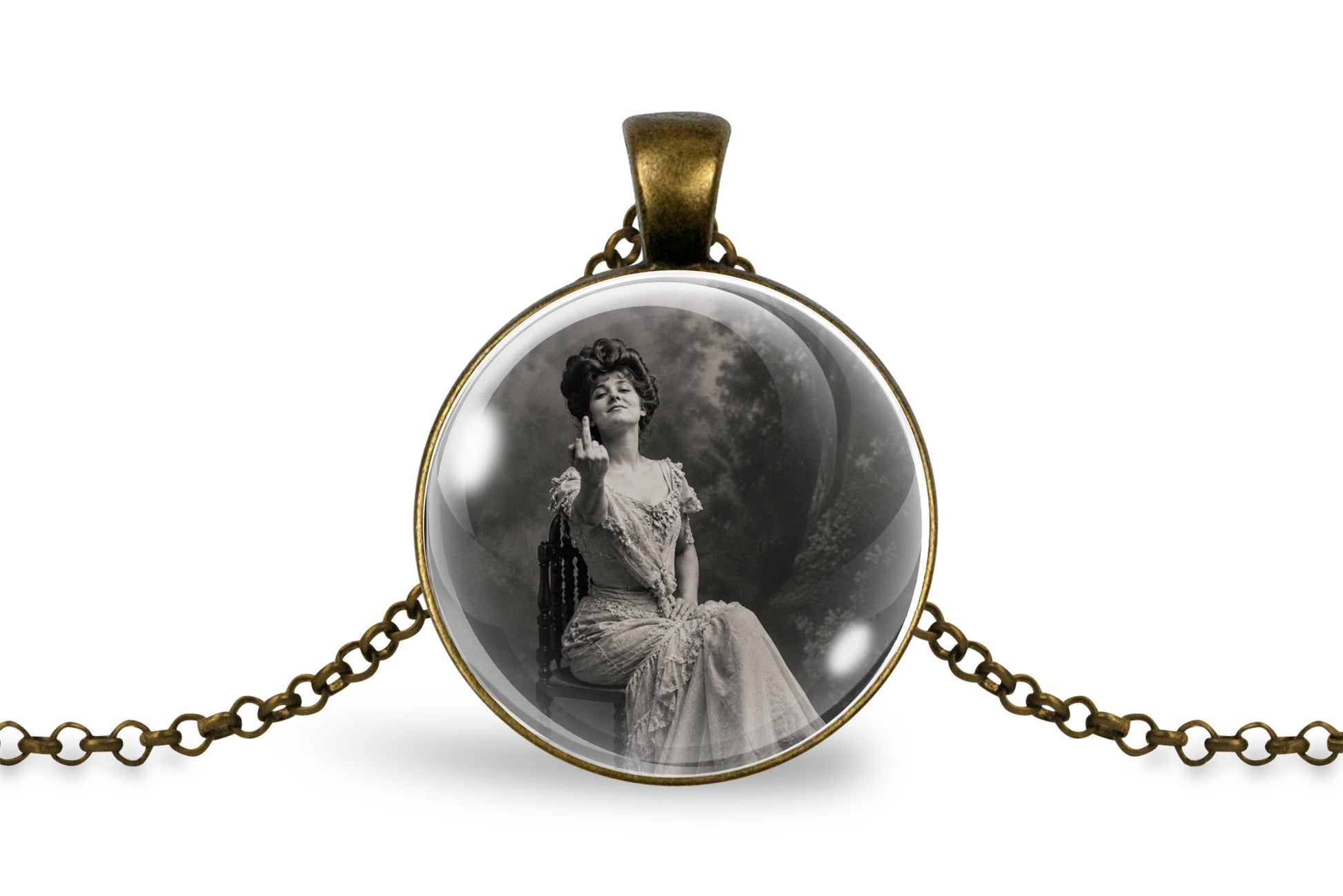 An antique bronze pendant necklace featuring a circular cabochon with a black and white vintage portrait of a seated woman, displayed on a clean white background.