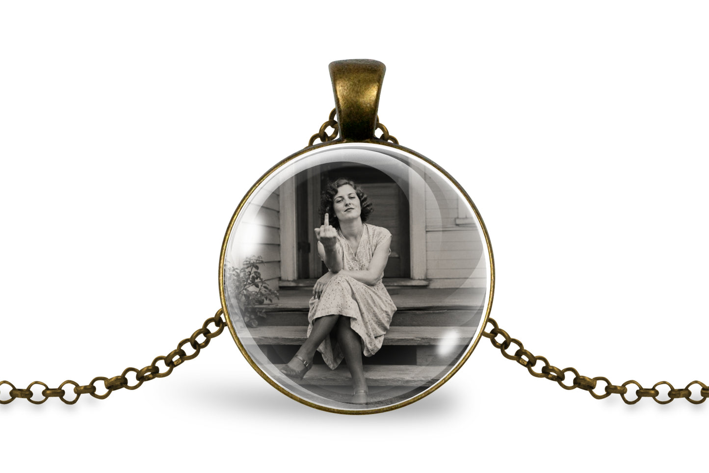 An antique inspired bronze round pendant necklace featuring a black and white vintage photograph of a woman sitting on steps, suspended on a matching chain against a white background.