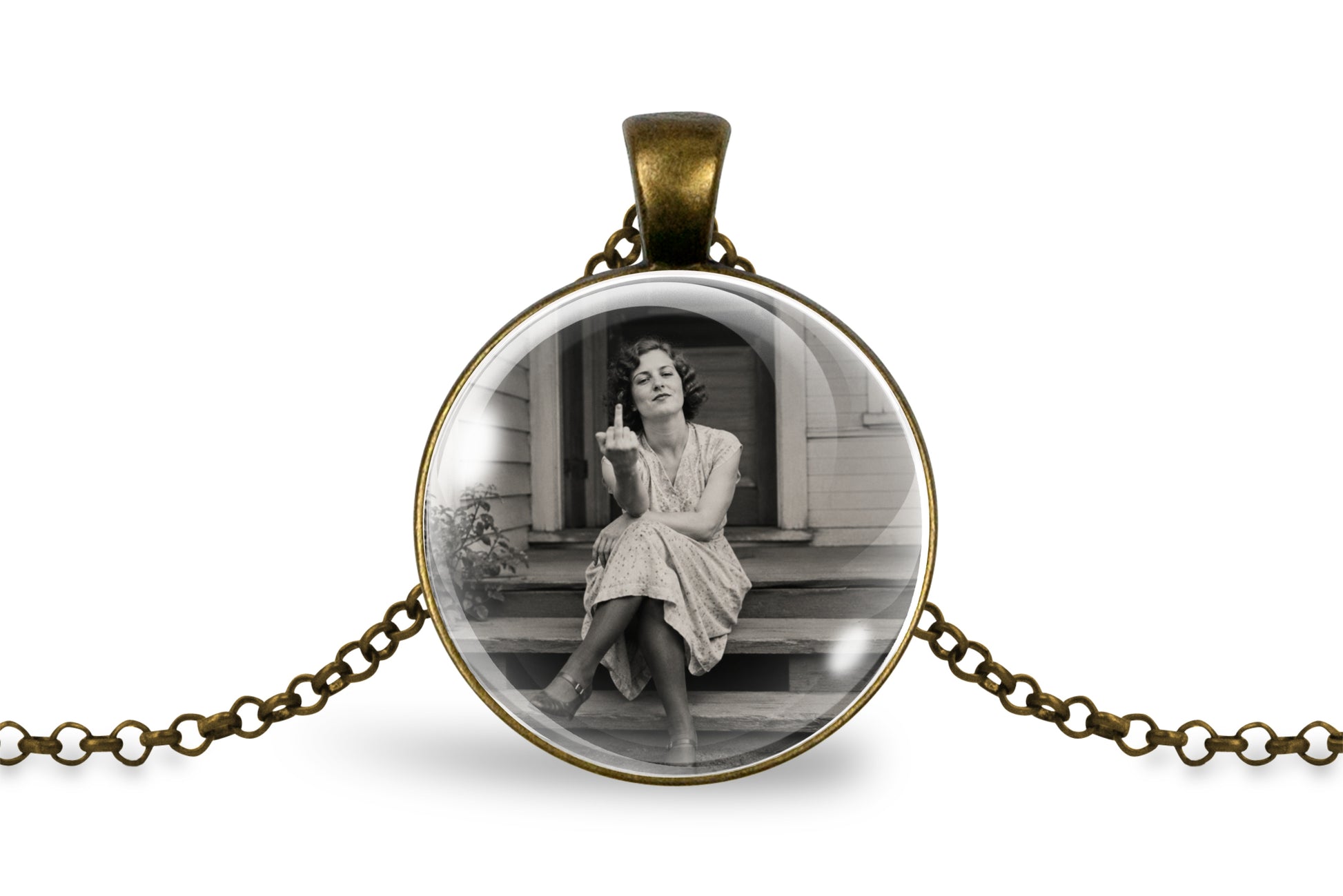 An antique inspired bronze round pendant necklace featuring a black and white vintage photograph of a woman sitting on steps, suspended on a matching chain against a white background.