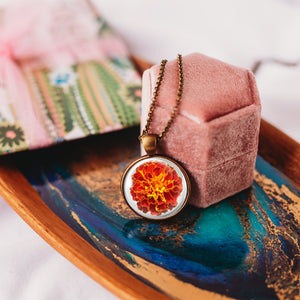 Glass cabochon pendant with orange marigold flower - Whimsy Spirit Shop