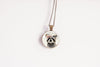Necklace with a pendant featuring a raccoon wearing a flower crown shown against a white background