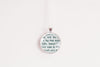 Historical romance necklace made from upcycled book page text under glass cabochon, shown against a white background