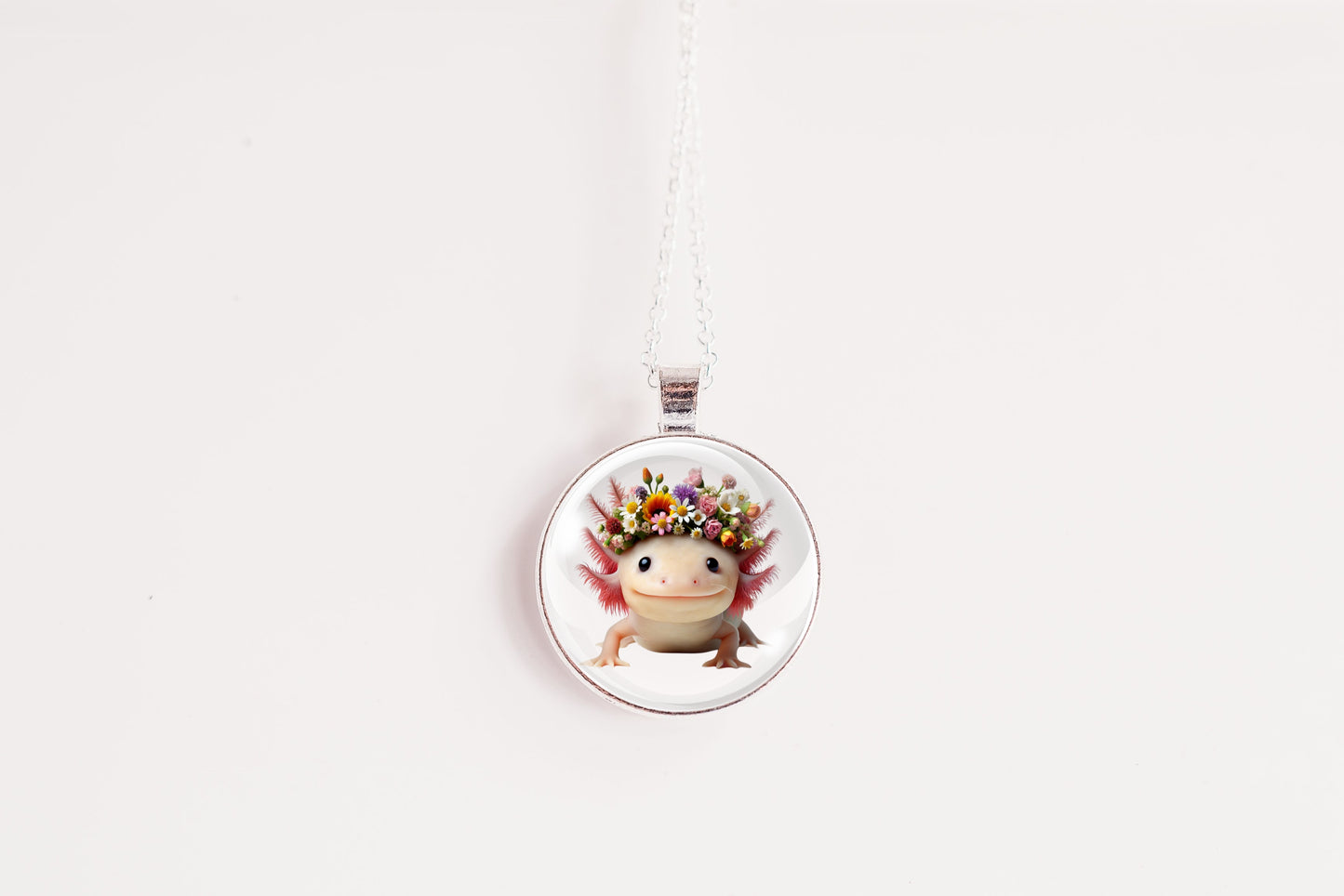 Necklace with a round pendant featuring a cute kawaii axolotl wearing a flower crown on a white background