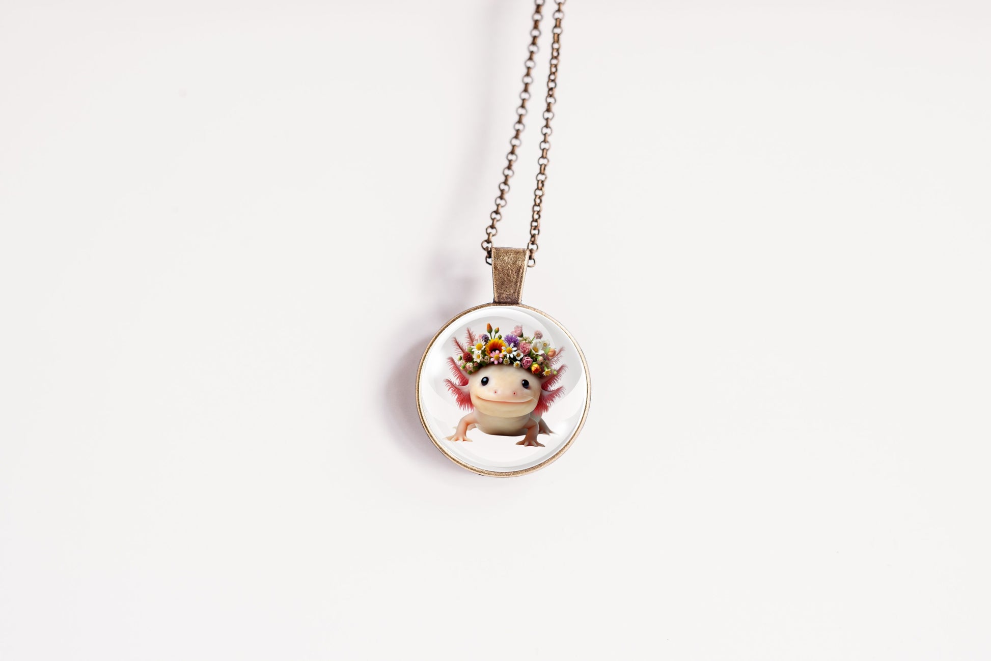 Necklace with a round pendant featuring a cute kawaii axolotl wearing a flower crown on a white background