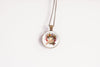 Necklace with a round pendant featuring a cute kawaii axolotl wearing a flower crown on a white background