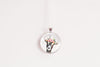Pendant necklace featuring the image of a goat wearing a flower crown, on a white background