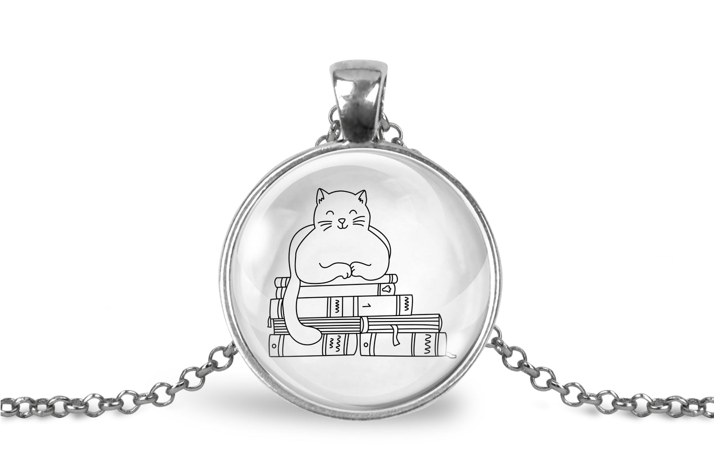 Glass cabochon pendant featuring a black line drawing of a cat sitting on stacked books