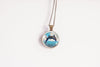 Necklace with a pendant featuring a dolphin in water on a white background