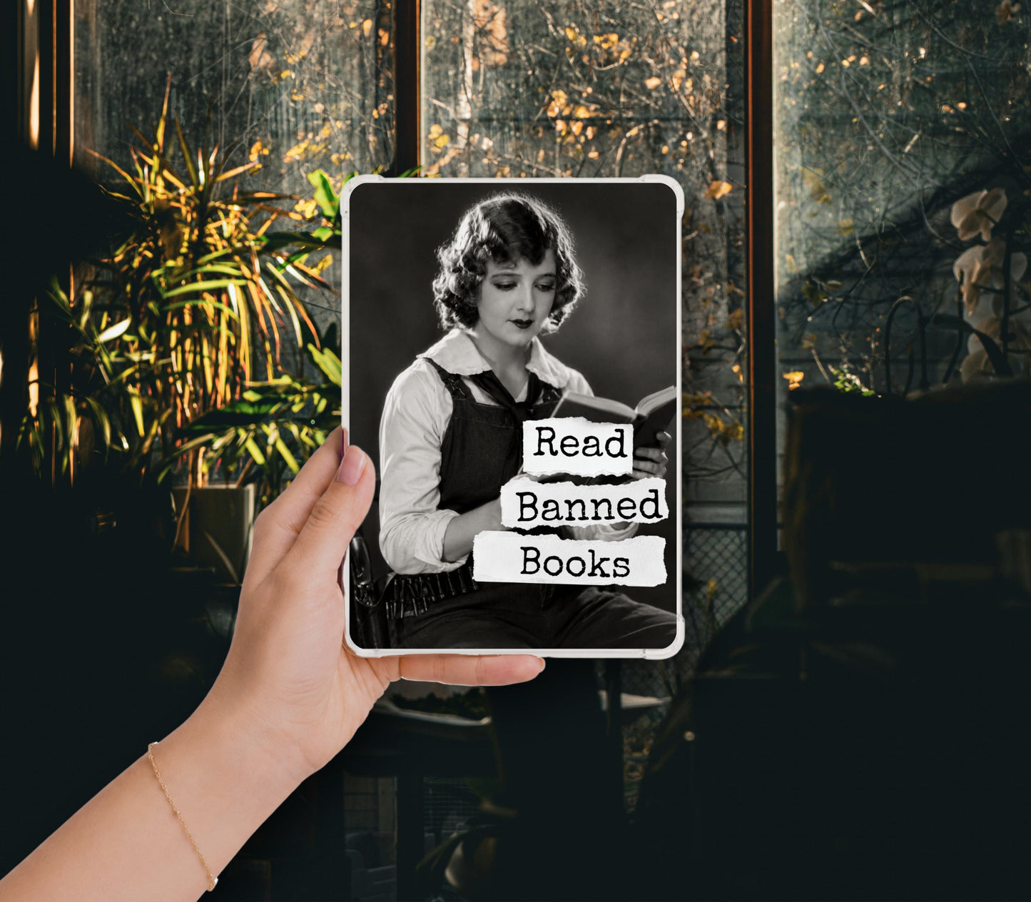 Read Banned Books printable Kindle clear case insert featuring a poised 1920s woman reading in a dark dress with a white collar, shown in a clear Kindle case held against a dark botanical background.