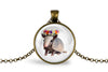 Pendant with armadillo wearing a flower crown inside a glass dome on a white background