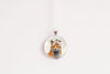 Round pendant with a fox design on a white background