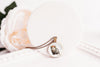 Necklace with a pendant featuring an opossum design on a white surface.