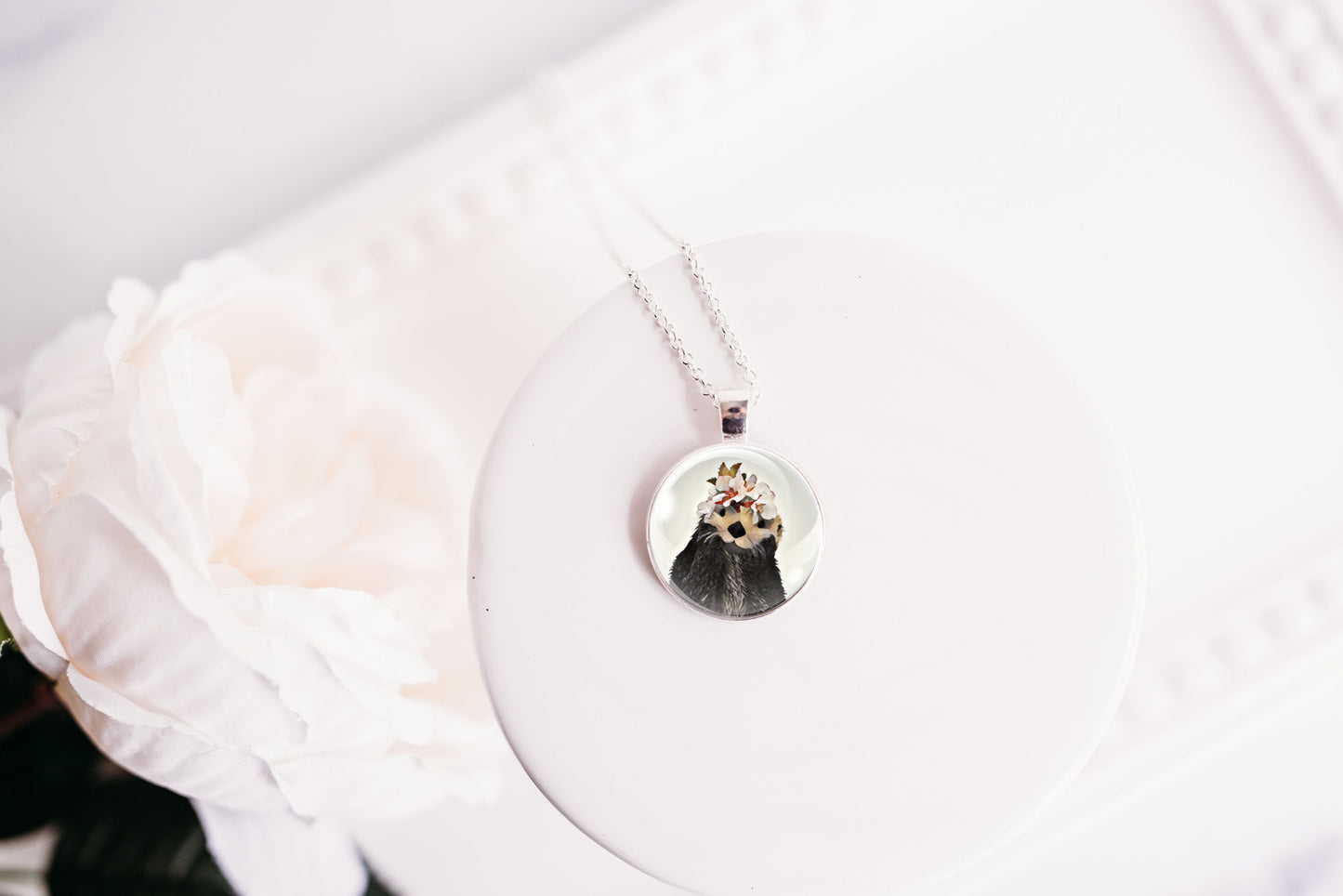 Necklace with a round otter pendant on a white background
