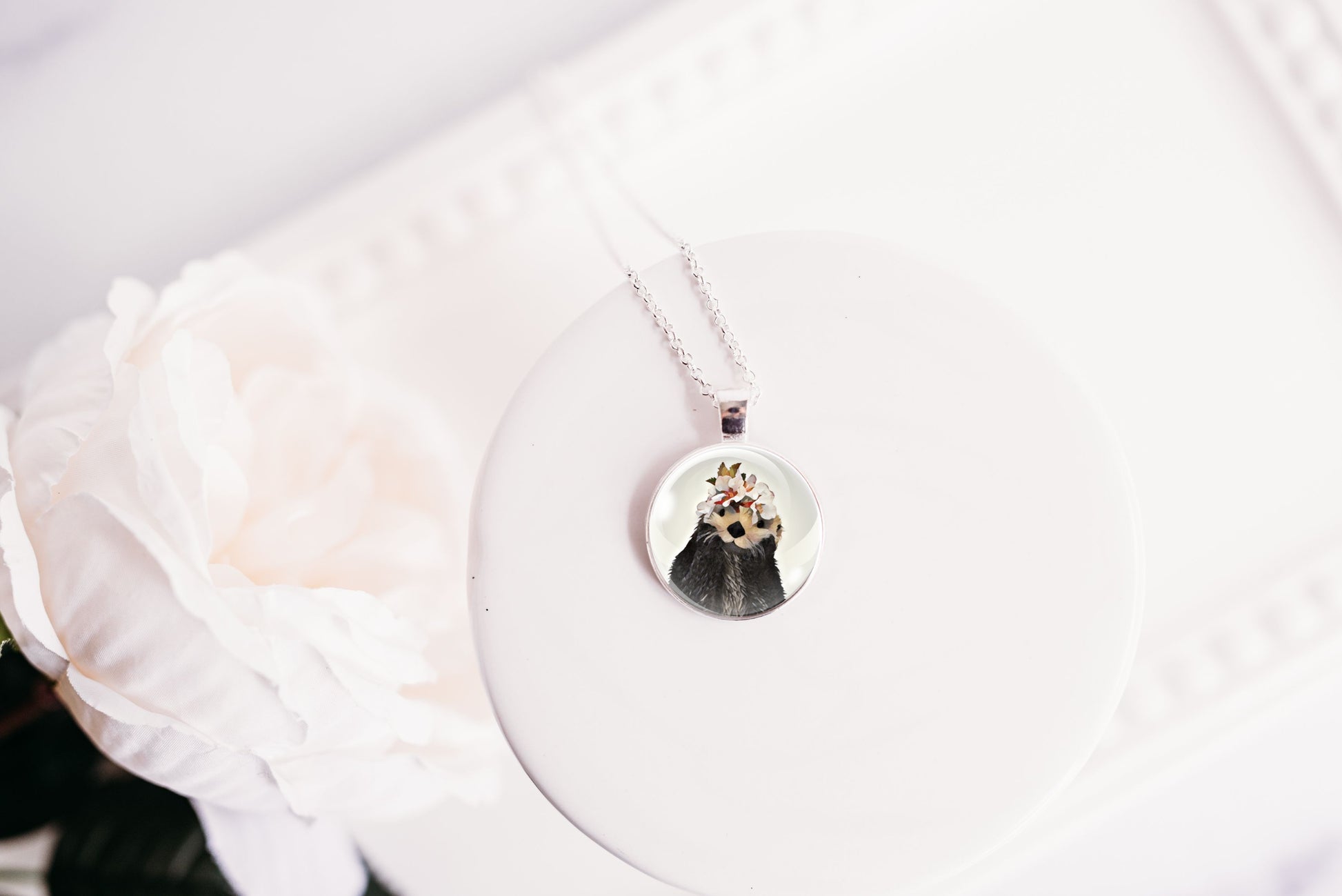 Necklace with a round otter pendant on a white background