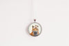 Round pendant with a fox design on a white background