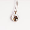 Farm animal jewelry goat pendant with floral crown against a white background