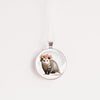 Necklace with a pendant featuring an opossum wearing a floral crown on a white background