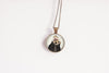 Necklace with a pendant featuring an otter wearing a flower crown design on a white background