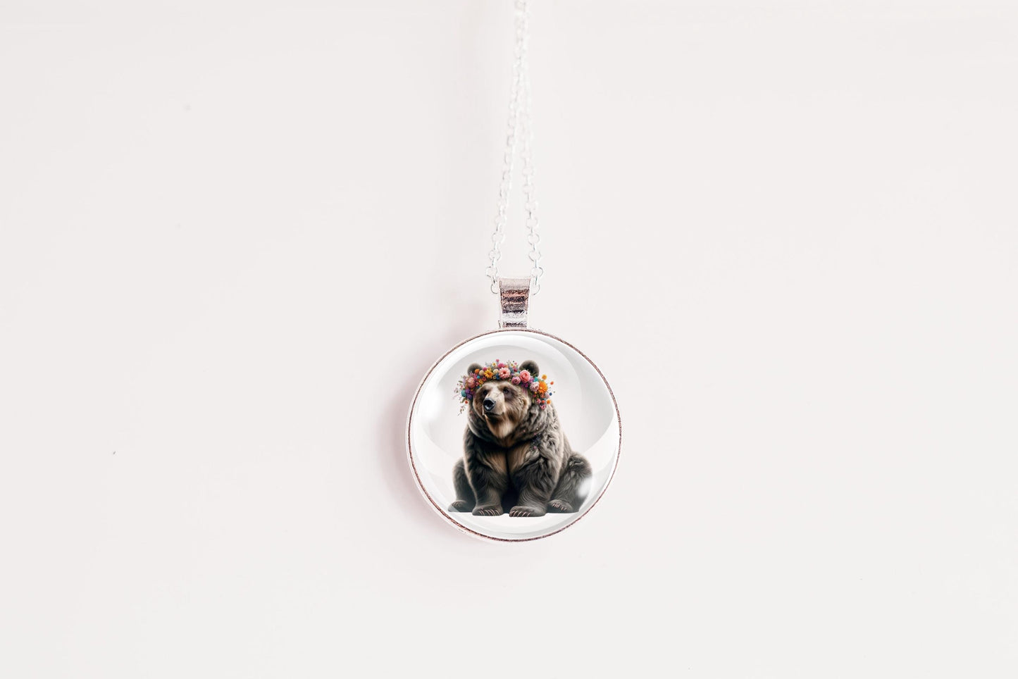 Round pendant with a bear design on a white background
