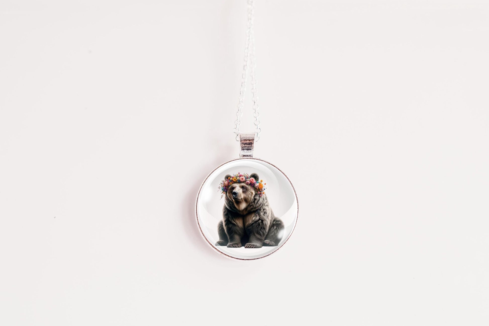 Round pendant with a bear design on a white background
