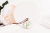 Lily of the Valley Necklace bronze-plated pendant with peach rose, angled lifestyle photo