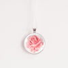 Rose birth flower necklace – pink rose glass cabochon pendant on silver-tone chain, white background