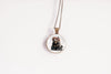 Necklace with a pendant featuring a bear design on a white background