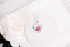 Water lily necklace July birth flower on white plate with soft floral styling – silver-tone pendant