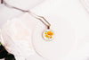 Necklace with a floral California poppies image pendant on a white background