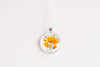 Necklace with a floral California poppies image pendant on a white background