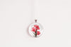 Gladiolus birth flower pendant, silver-tone chain, glass cabochon necklace on white background