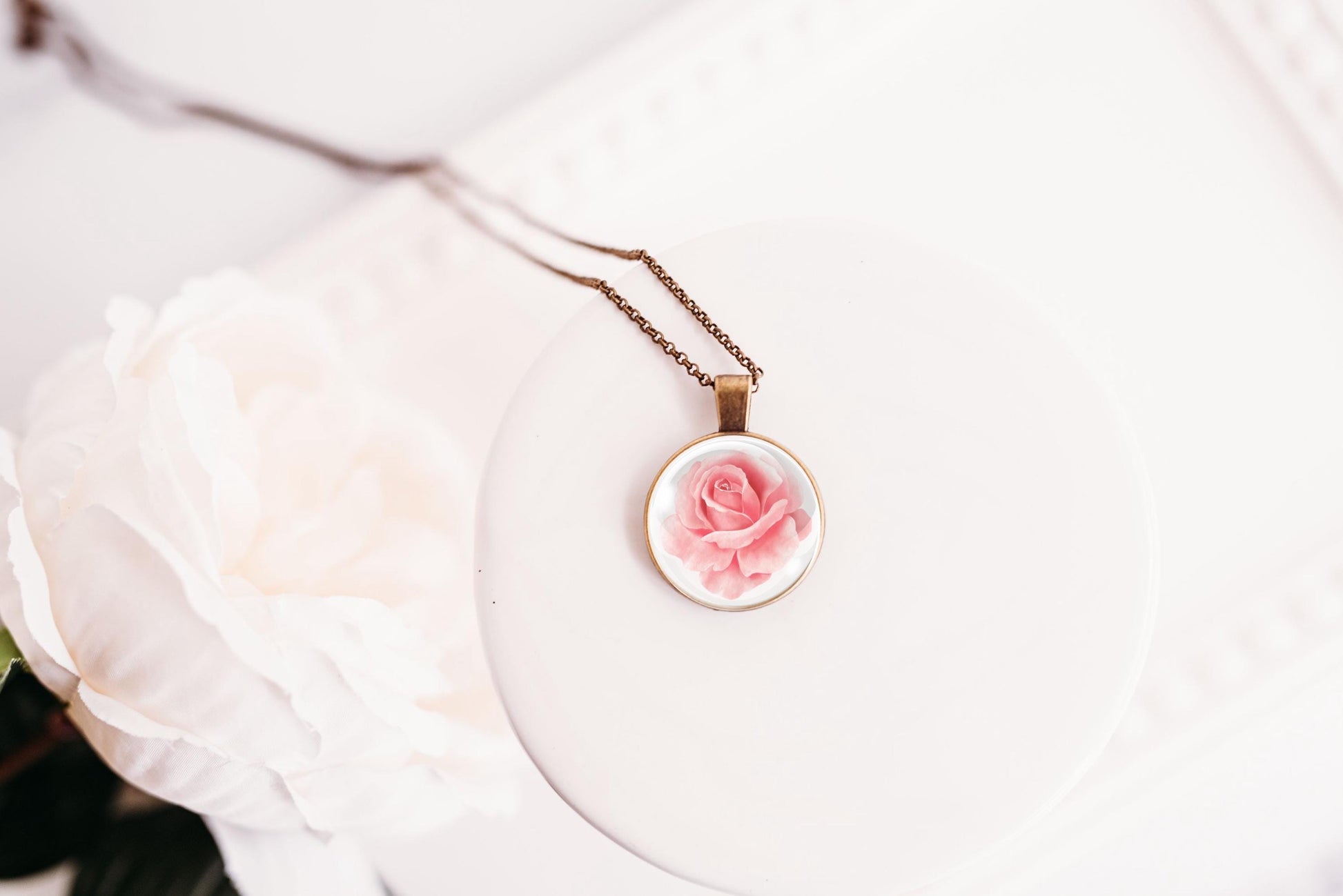 Rose birth flower necklace close-up detail – glass cabochon pendant with pink rose illustration